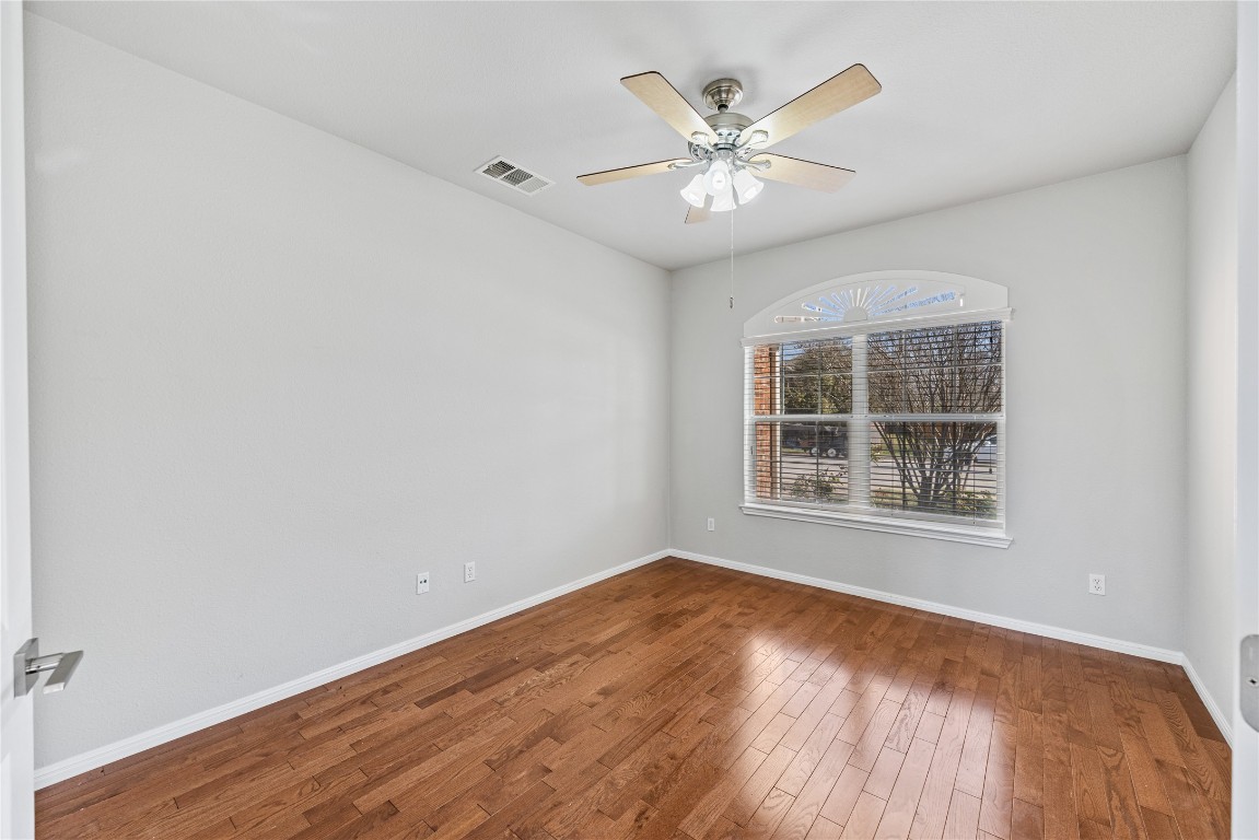 12017 Lansdowne Road Austin, TX 78754 - Photo 17 of 30 a view of an empty room with wooden floor and a window