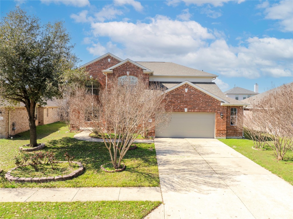 12017 Lansdowne Road Austin, TX 78754 - Photo 2 of 30 a view of a house with a yard and a garage