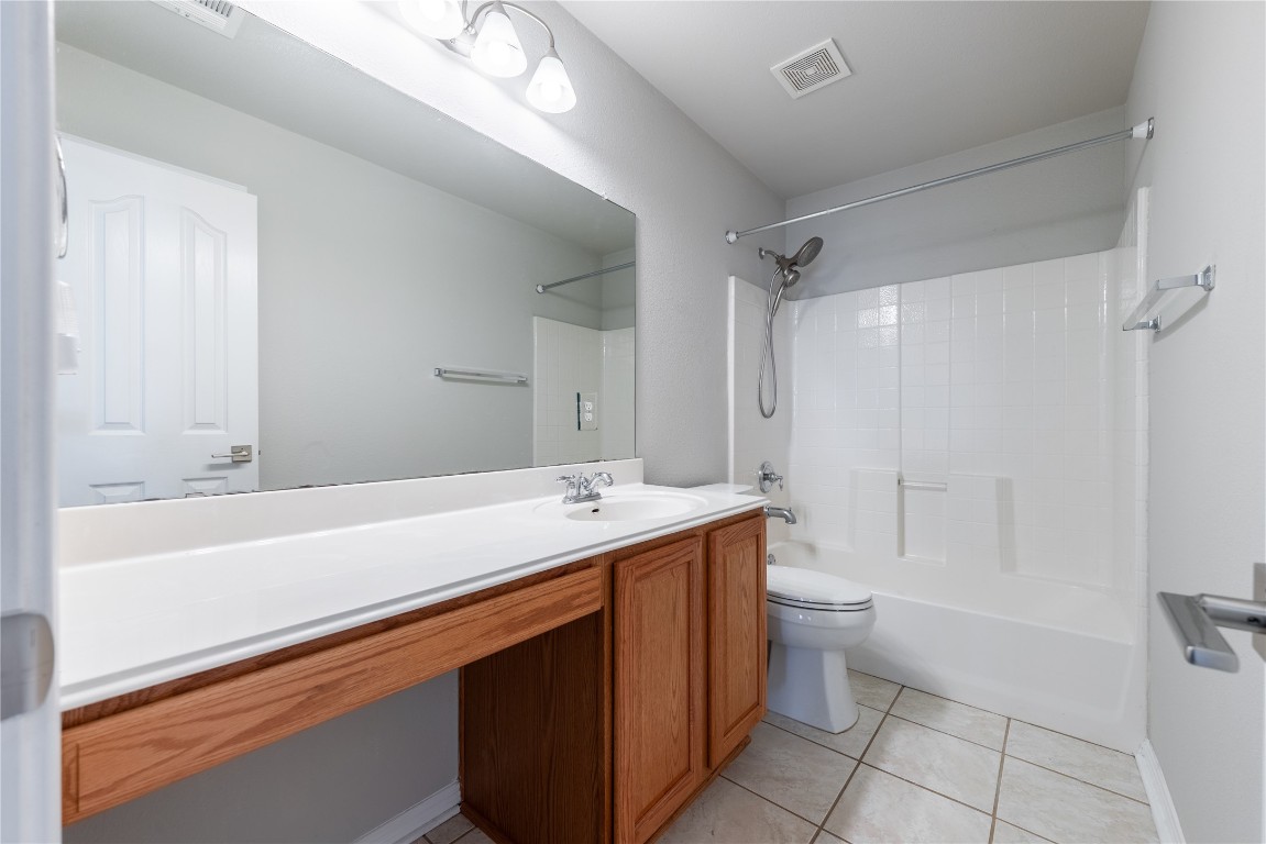 12017 Lansdowne Road Austin, TX 78754 - Photo 21 of 30 a bathroom with a sink a toilet and shower