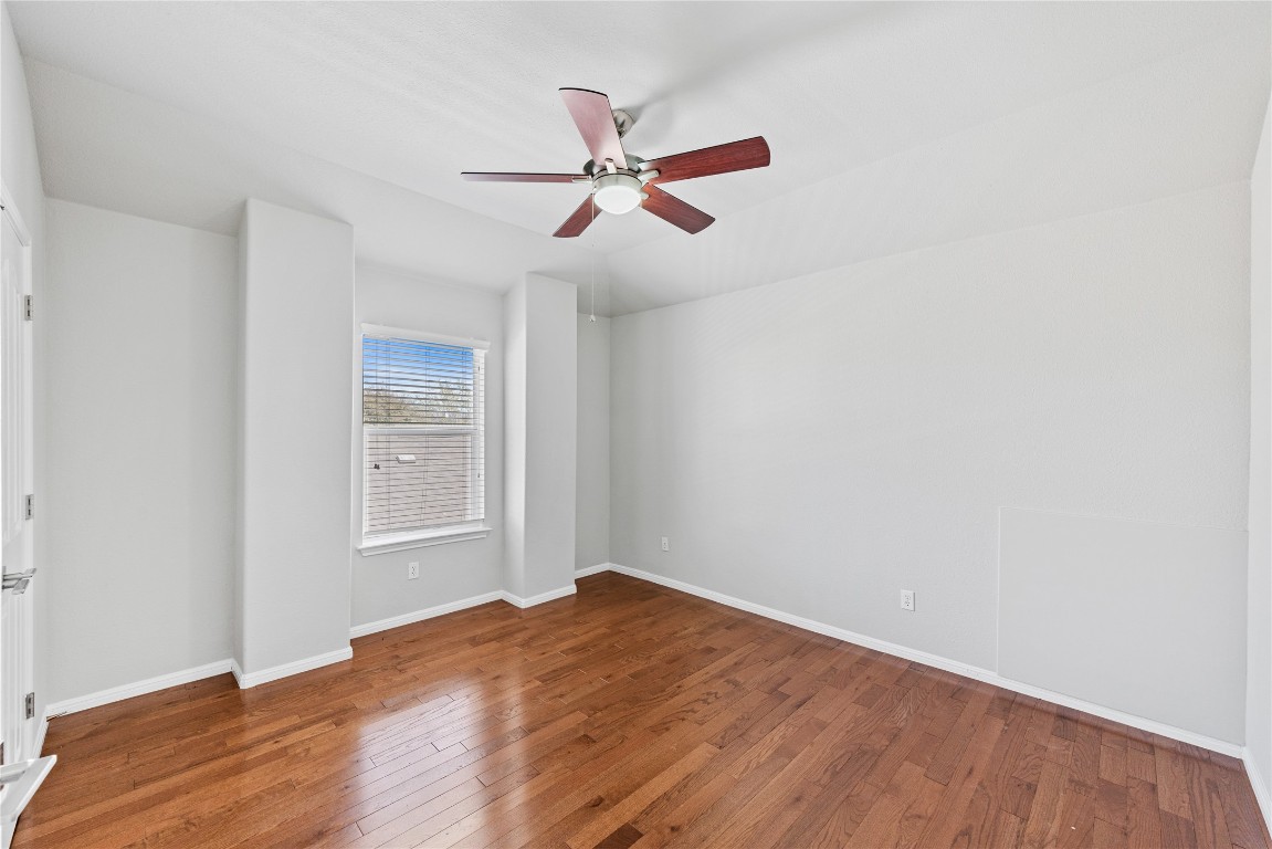 12017 Lansdowne Road Austin, TX 78754 - Photo 22 of 30 a view of empty room with wooden floor and fan
