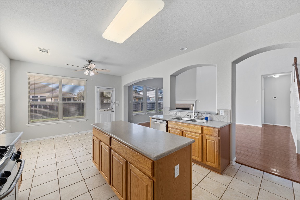 12017 Lansdowne Road Austin, TX 78754 - Photo 8 of 30 a room with kitchen island a sink a stove and a window