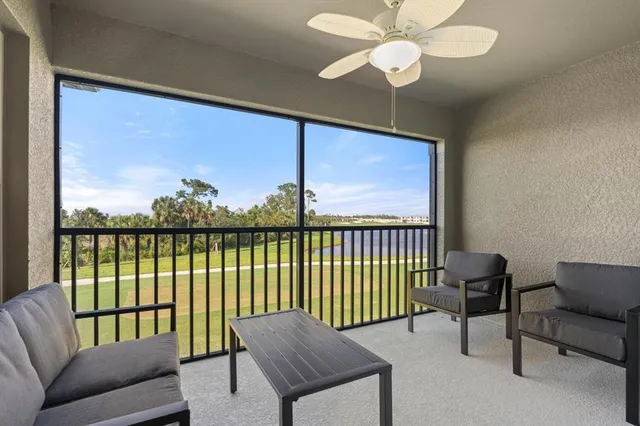 a living room with furniture and a floor to ceiling window