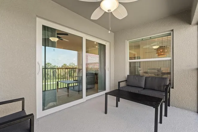 a view of a livingroom with furniture and a window