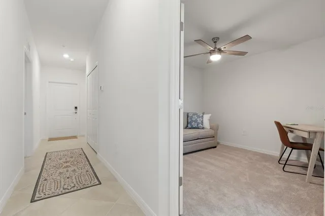 a view of room with a ceiling fan and a wooden floor
