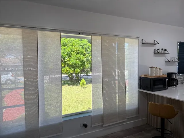 a view of kitchen with furniture and large window