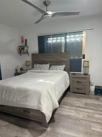 a bedroom with a bed and a mirror