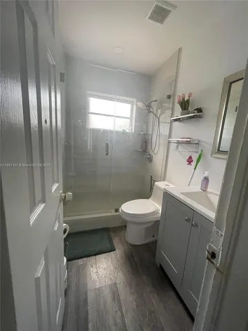 a white toilet sitting next to a bathroom sink