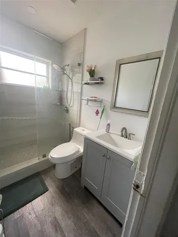 a bathroom with a toilet sink and shower