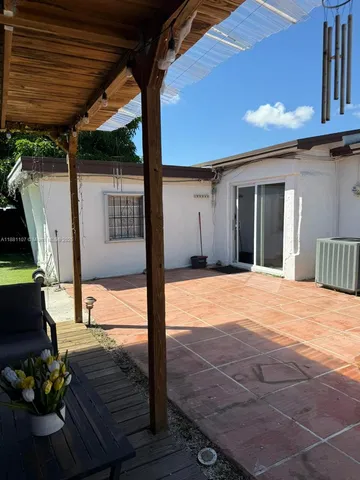 a view of an empty room with floor to ceiling window and wooden floor