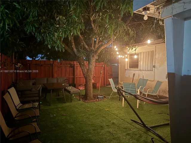 a view of a chairs and table in patio