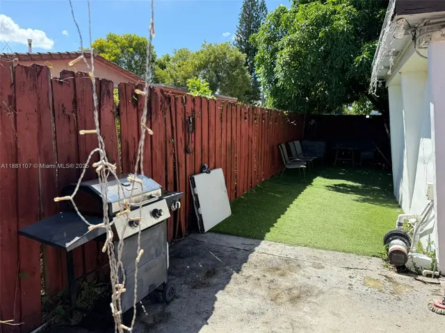 a view of a backyard with wooden fence