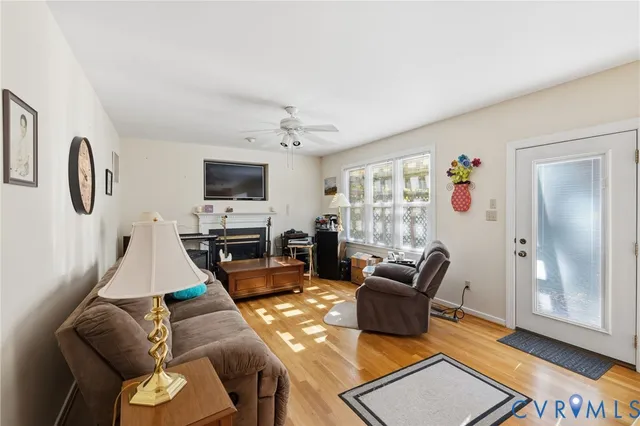 a living room with furniture and wooden floor
