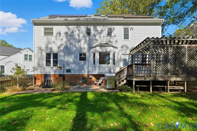 a backyard of a house with barbeque oven and trees