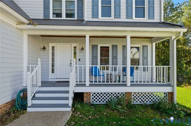 a view of a house with a wooden fence