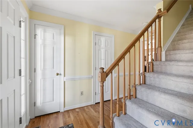 a view of an entryway with wooden floor and door