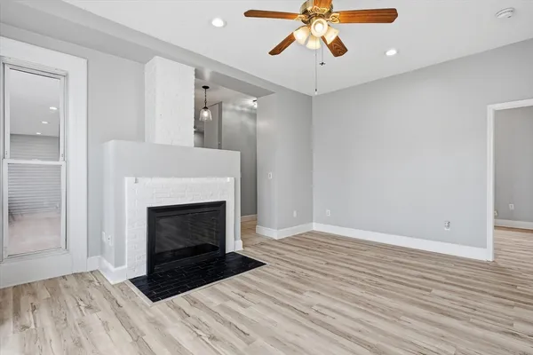 a view of an empty room with wooden floor