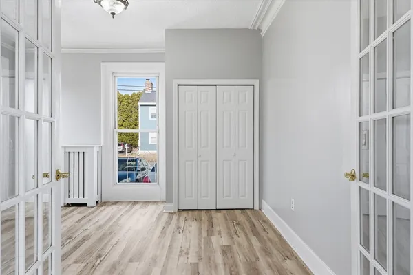 a view of empty room with wooden floor