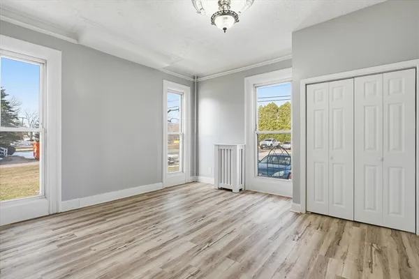 a view of an empty room with wooden floor