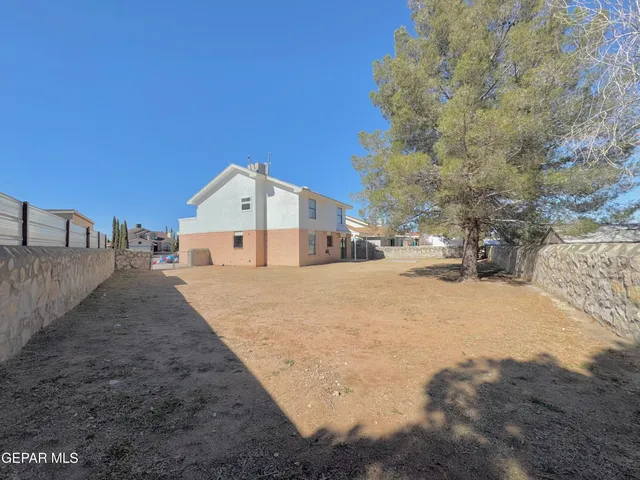 a view of white house with a yard