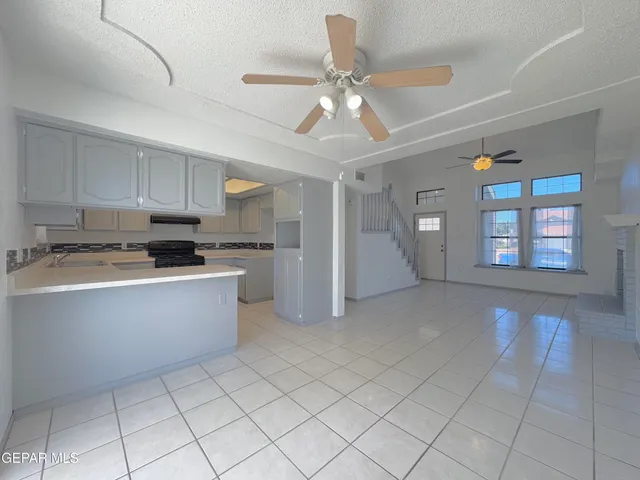 a kitchen with stainless steel appliances granite countertop a refrigerator and a stove top oven