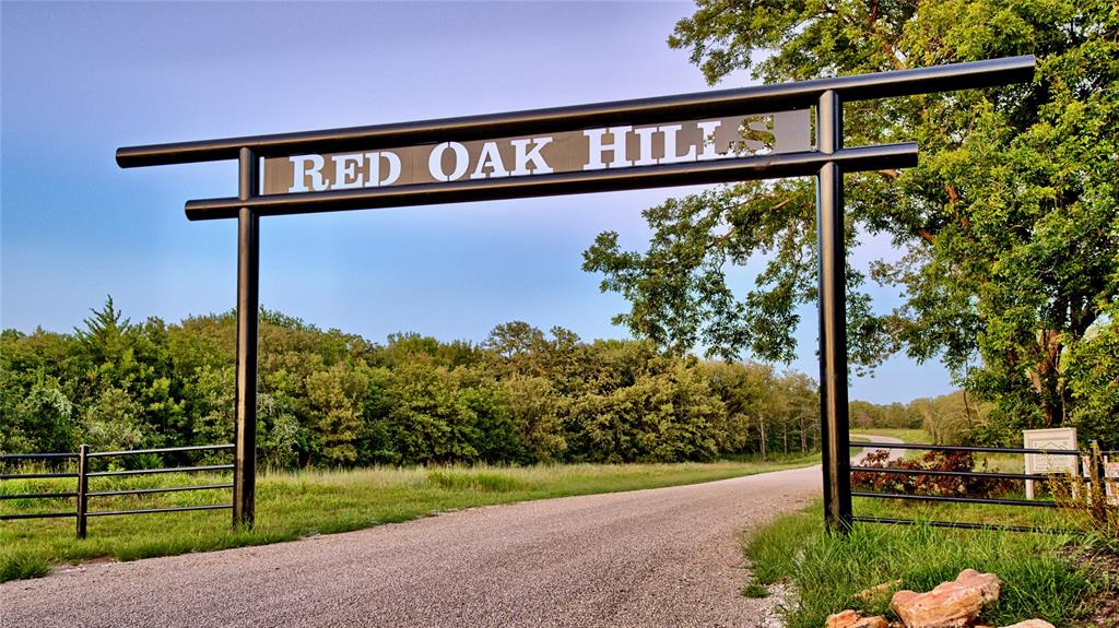 Lot 34 Red Oak Hills Road Nocona, TX 76255 - Photo 2 of 24 a view of a street with a sign board