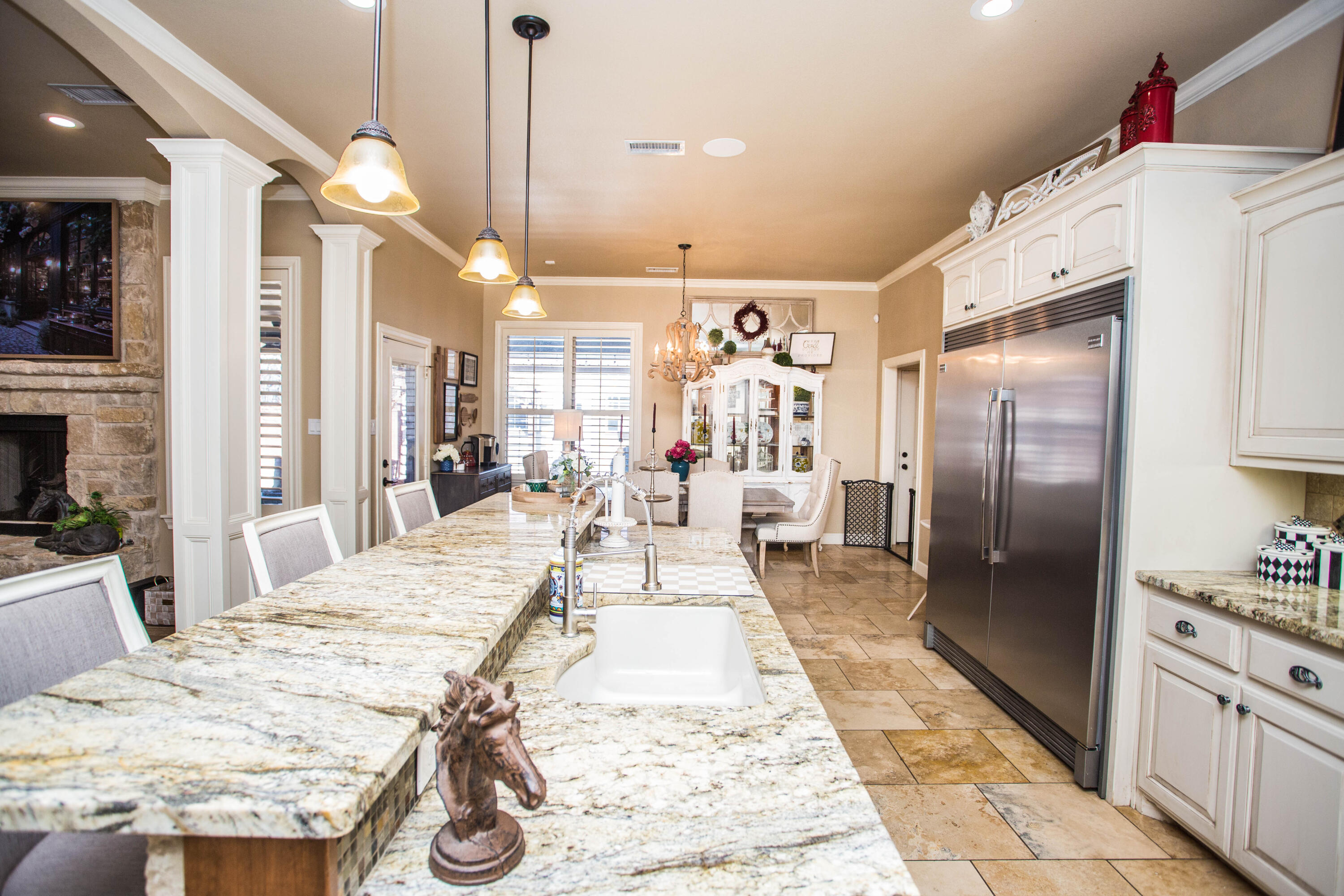 6018 87th Street Lubbock, TX 79424 - Photo 16 of 98 a large kitchen with stainless steel appliances kitchen island granite countertop a refrigerator oven a sink dishwasher and a dining table with wooden floor