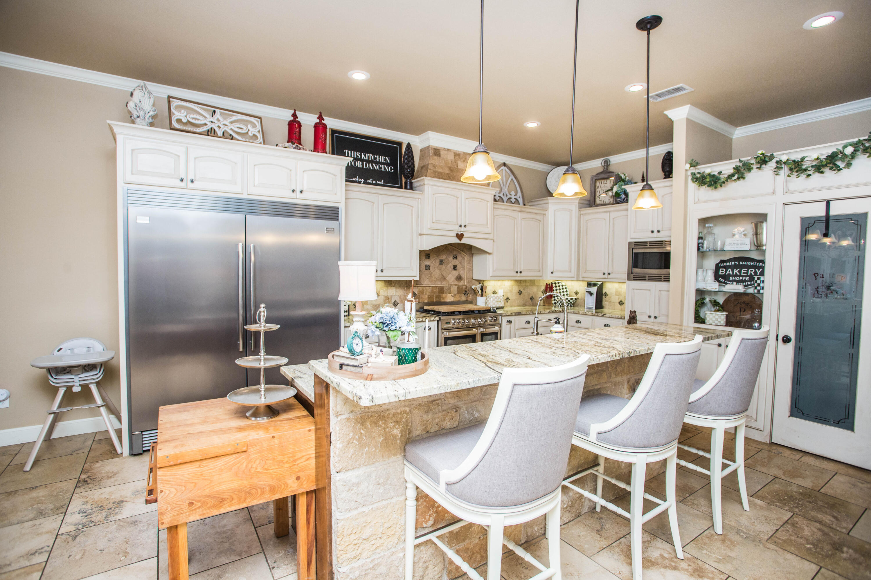 6018 87th Street Lubbock, TX 79424 - Photo 21 of 98 a kitchen with stainless steel appliances kitchen island granite countertop a table and chairs