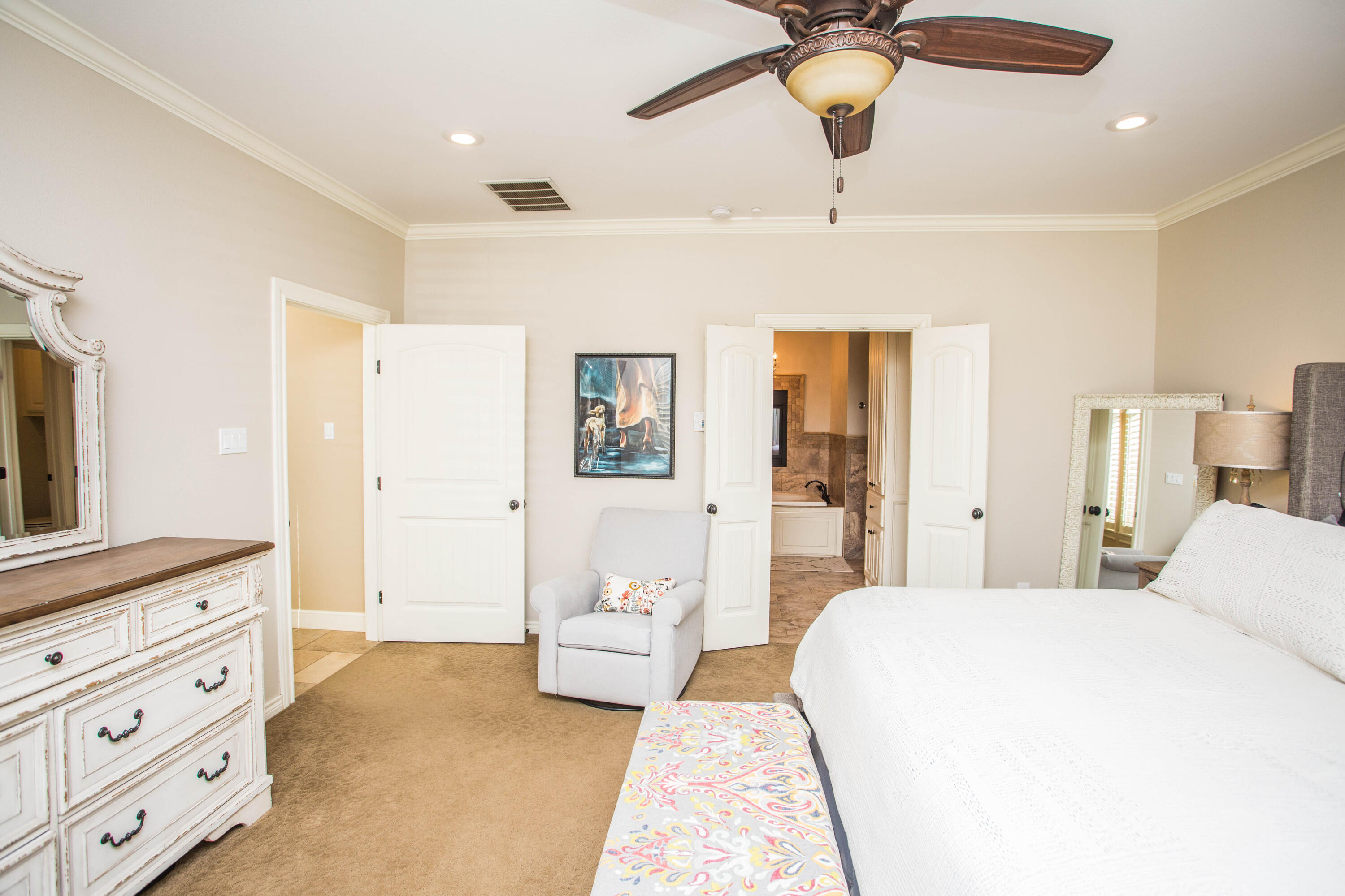6018 87th Street Lubbock, TX 79424 - Photo 29 of 98 a spacious bedroom with a bed and ceiling fan