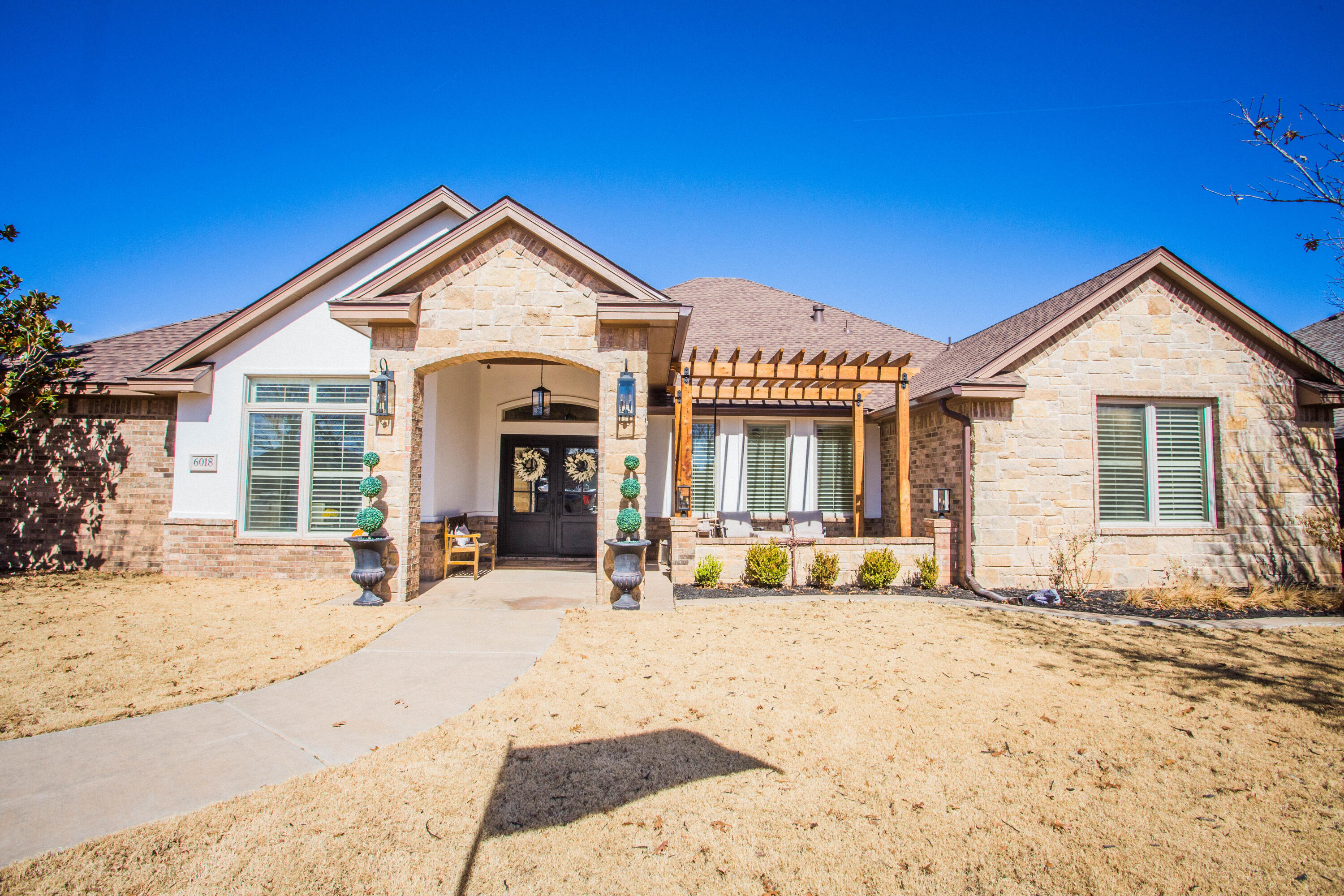 6018 87th Street Lubbock, TX 79424 - Photo 4 of 98 a view of a house with wooden fence next to a yard