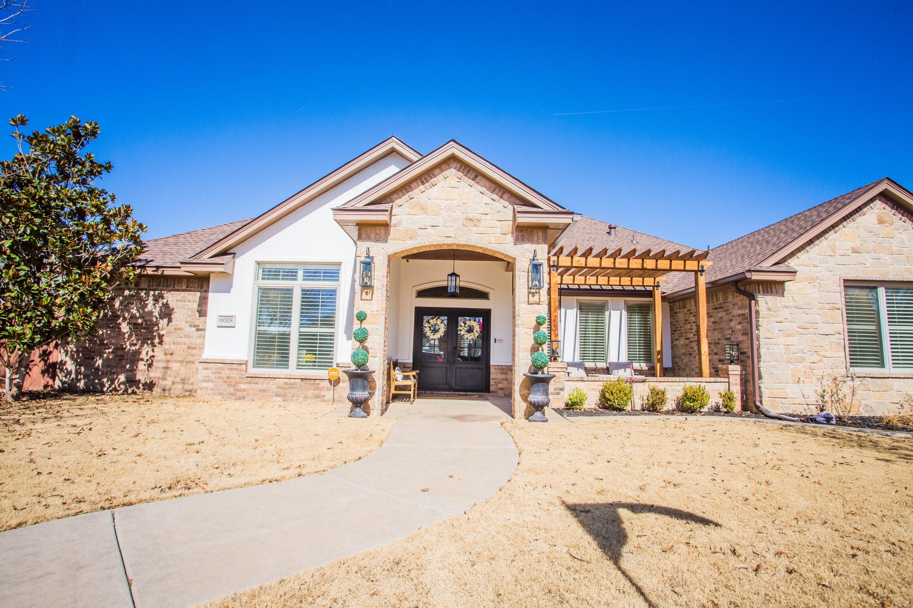 6018 87th Street Lubbock, TX 79424 - Photo 5 of 98 a view of a house with snow on the side of road