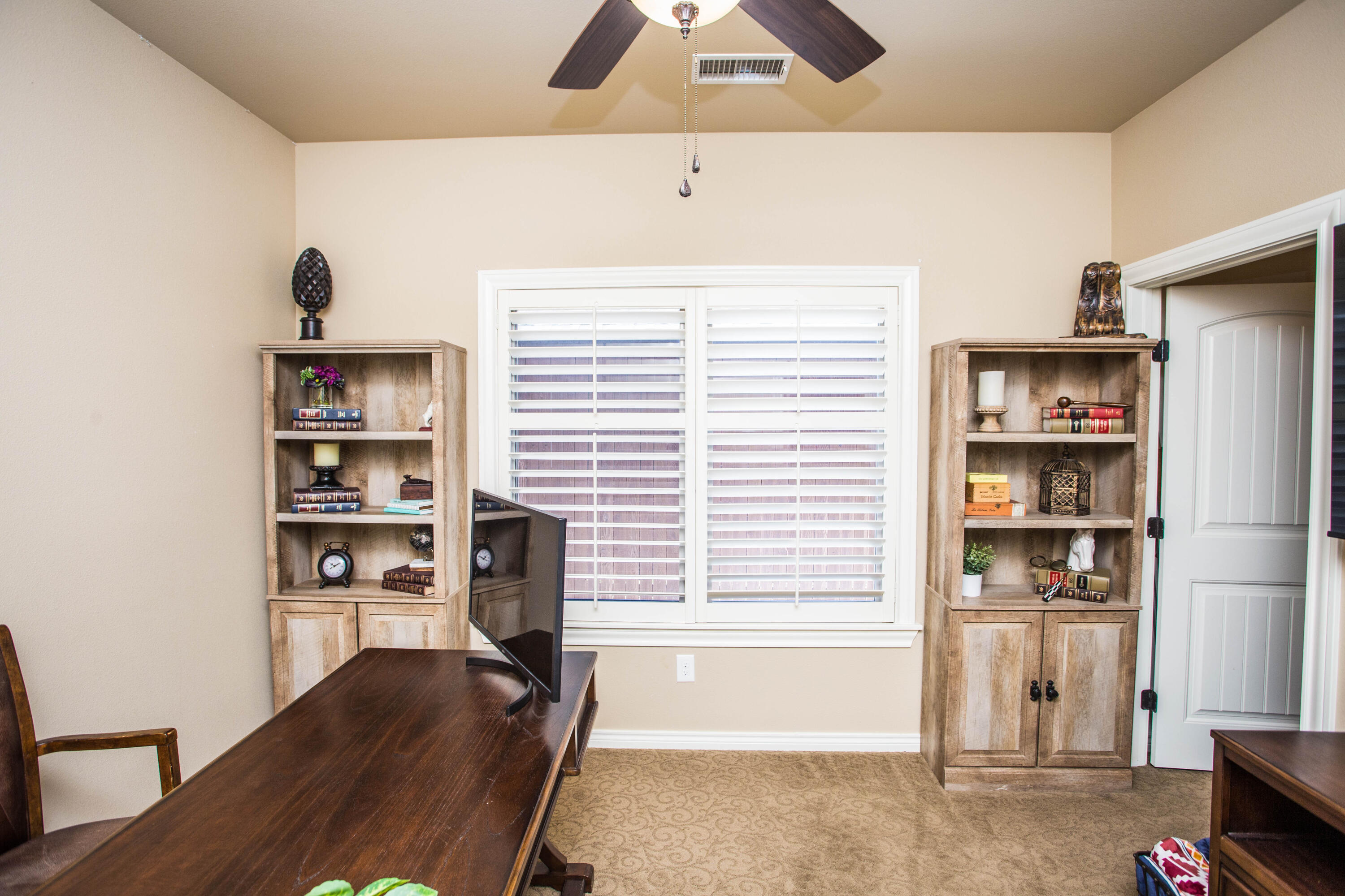 6018 87th Street Lubbock, TX 79424 - Photo 63 of 98 a view of a workspace with furniture and natural light
