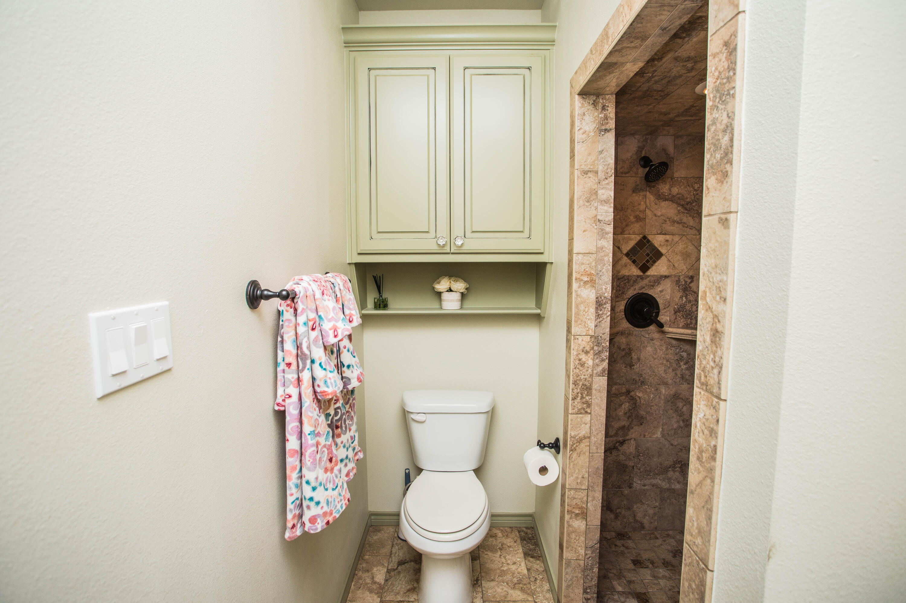 6018 87th Street Lubbock, TX 79424 - Photo 67 of 98 a bathroom with a toilet and a shower curtain