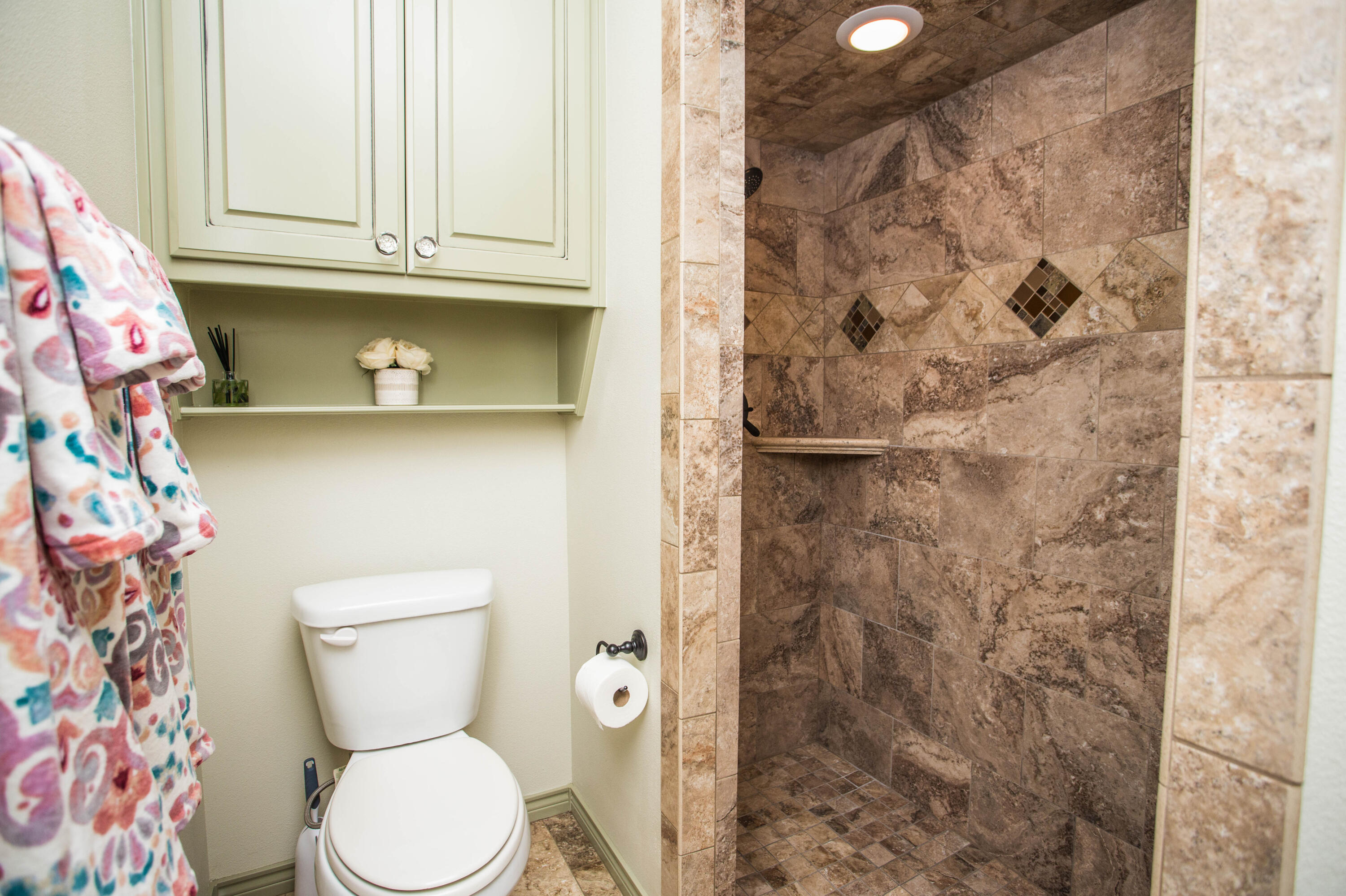 6018 87th Street Lubbock, TX 79424 - Photo 68 of 98 a bathroom with a toilet and a shower curtain