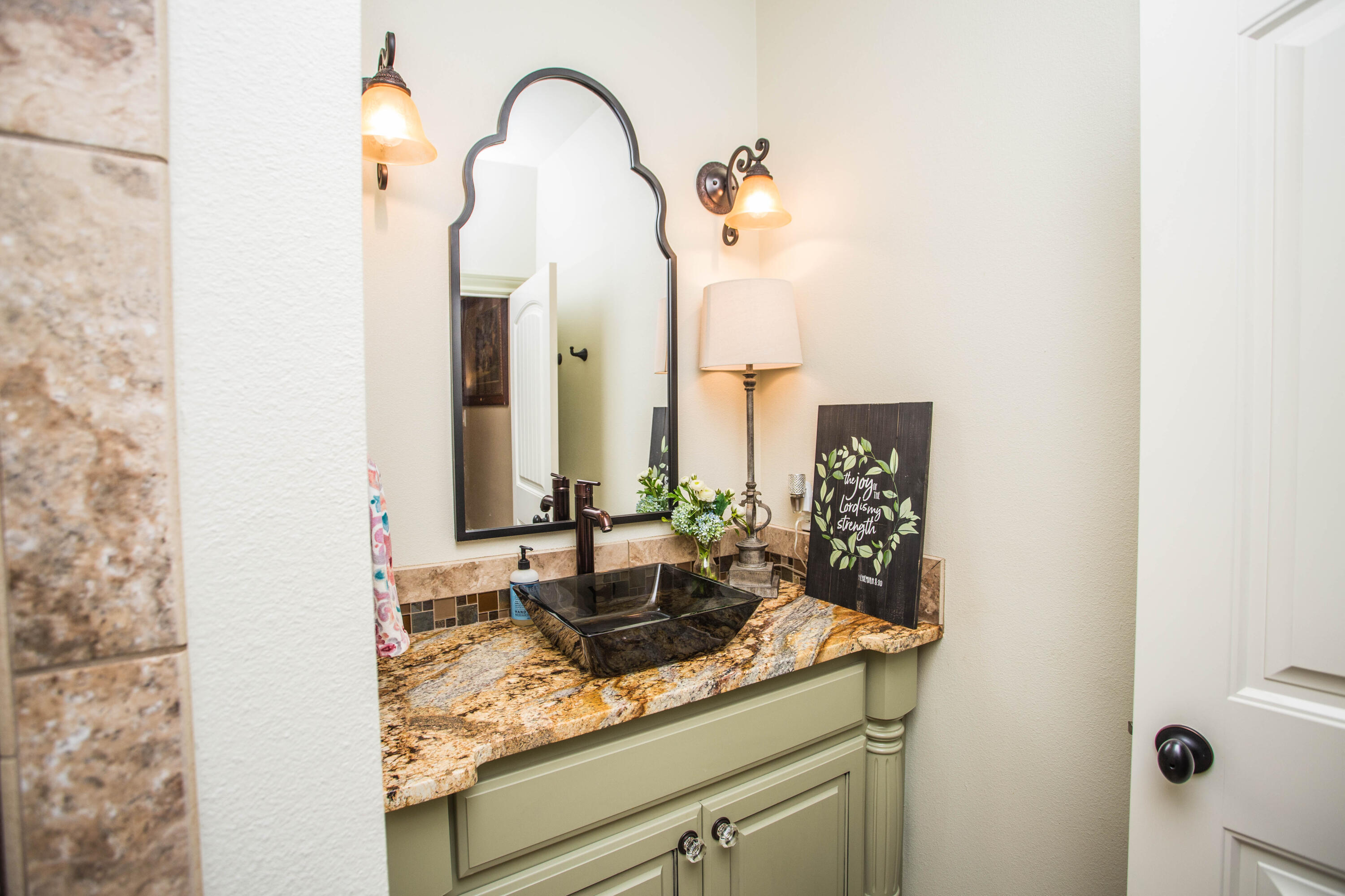 6018 87th Street Lubbock, TX 79424 - Photo 70 of 98 a bathroom with a sink and a mirror