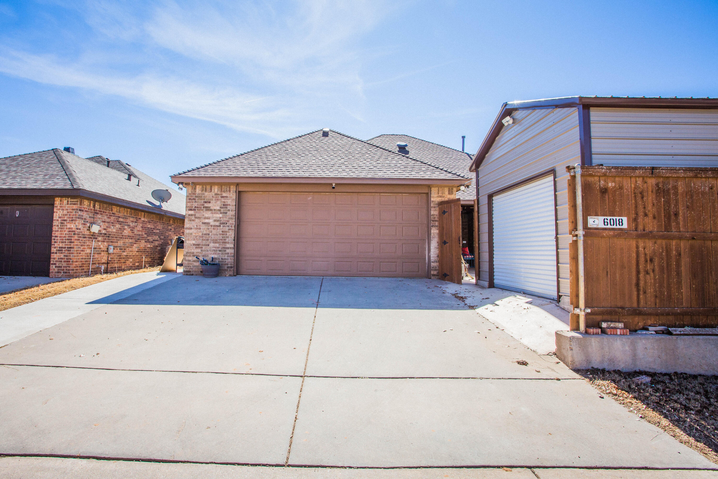 6018 87th Street Lubbock, TX 79424 - Photo 87 of 98 a front view of a house with a yard and garage