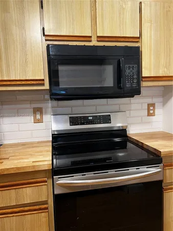 a kitchen with a stove and a microwave