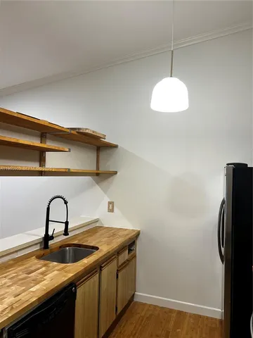 a close view of a sink and a refrigerator