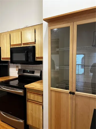a view of a kitchen from a empty room