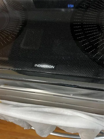 a kitchen with wooden floor and a stove top oven