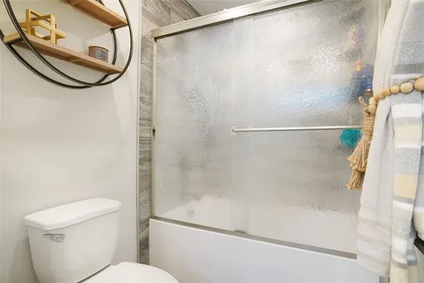 a bathroom with a shower and a toilet
