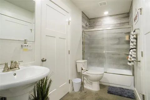 a bathroom with a sink toilet and shower