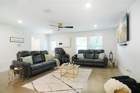 a living room with furniture and a large window