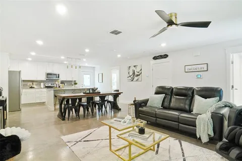 a living room with furniture and kitchen view