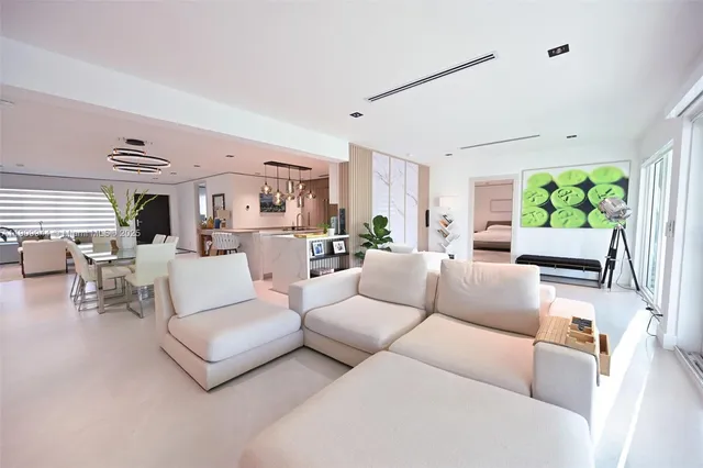 a living room with furniture fireplace and a large window