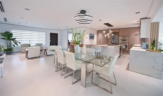 a living room with fireplace furniture and a large window