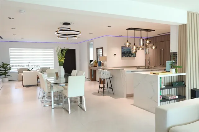 a view of a dining room with furniture and chandelier