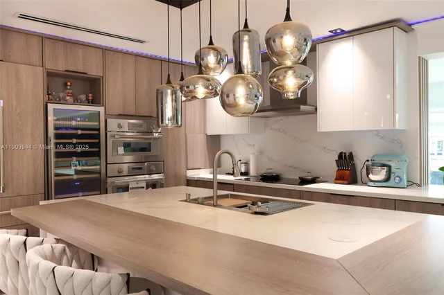 a kitchen with kitchen island a sink appliances and cabinets