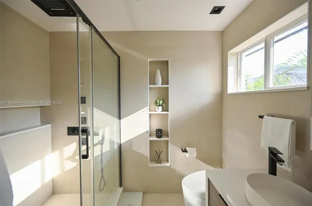 a bathroom with a toilet sink and a mirror