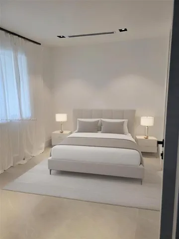 a bedroom with a bed and a night stand