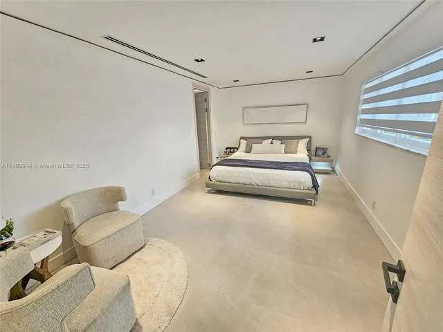 a spacious bedroom with a bed and a couch